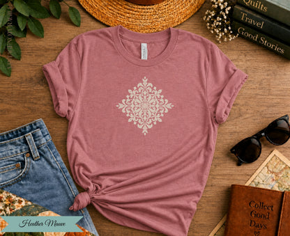Heather Mauve t-shirt with cream ornate mandala design and rolled sleeves.