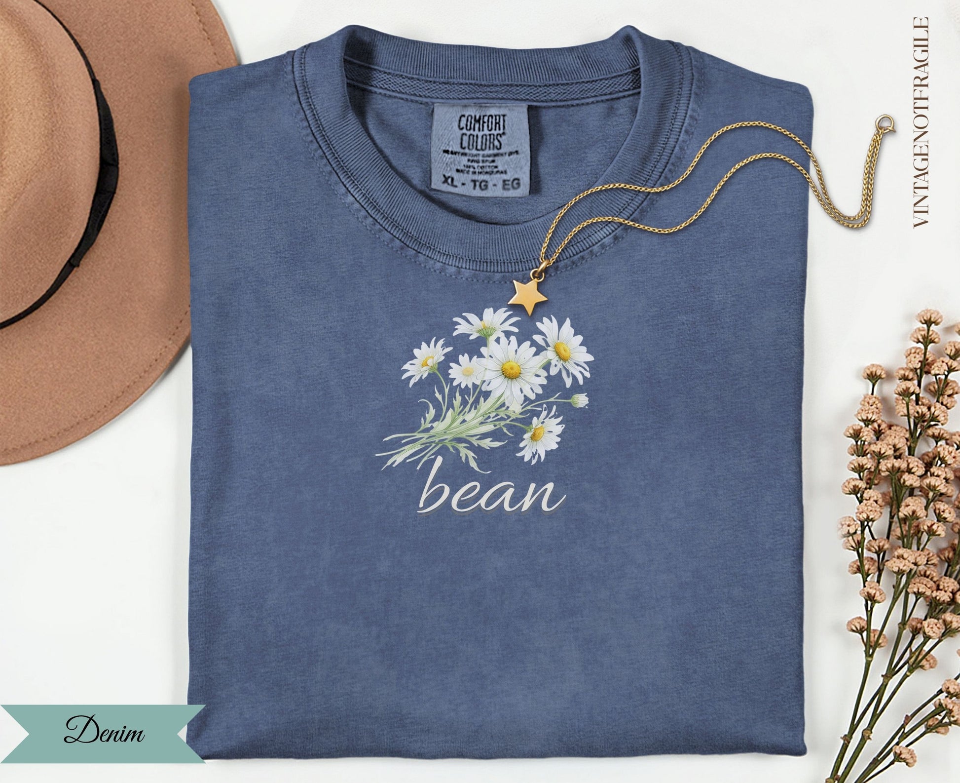 Denim t-shirt with white daisy bouquet graphic and "bean" text.