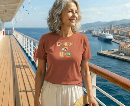 Woman wearing a rust-colored t-shirt with "enough as I am" text.