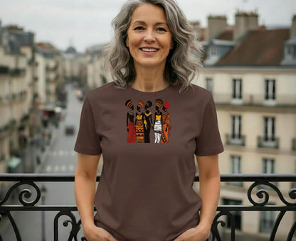 Woman wearing a brown t-shirt with an African-inspired art design.