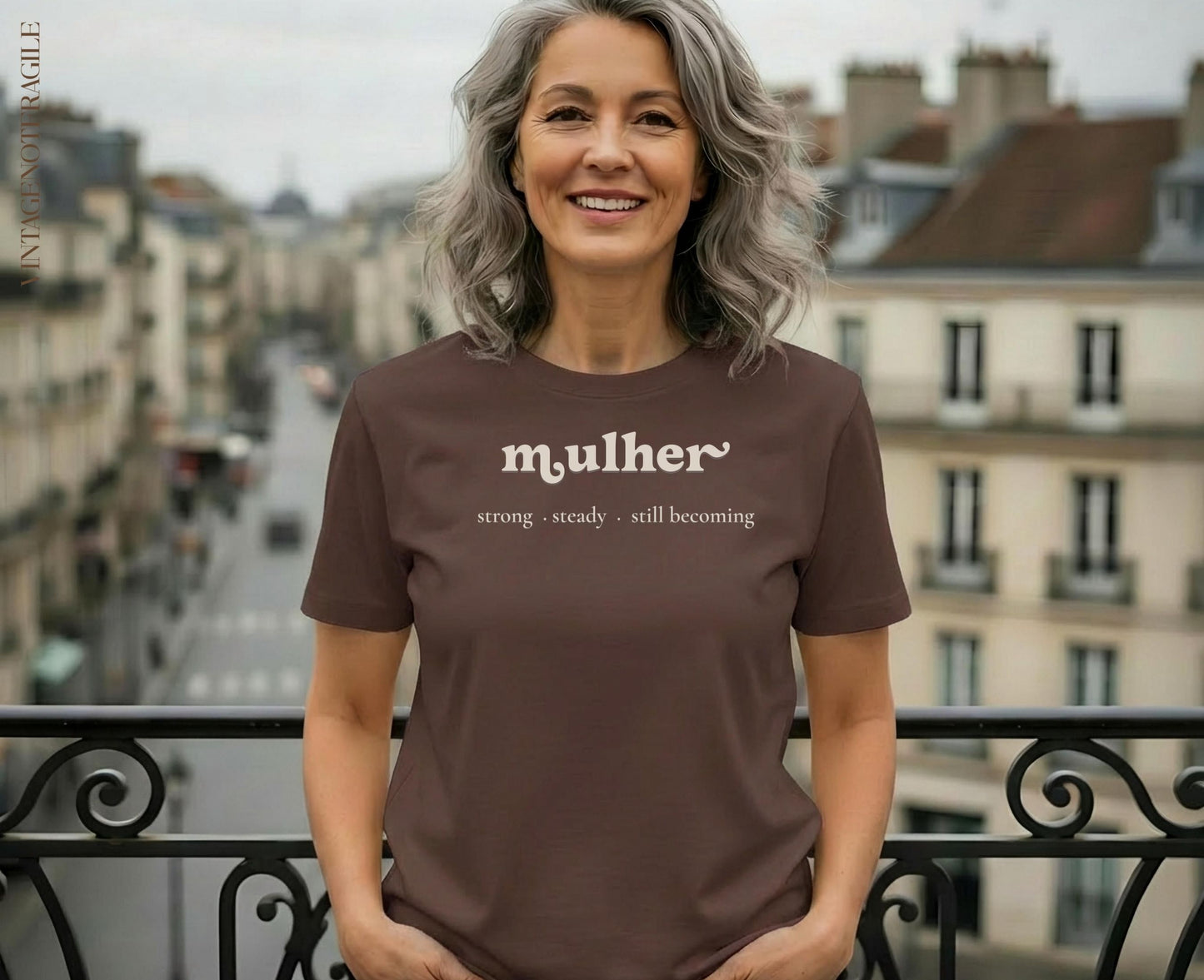 Woman in brown t-shirt with "mulher strong steady still becoming" text.