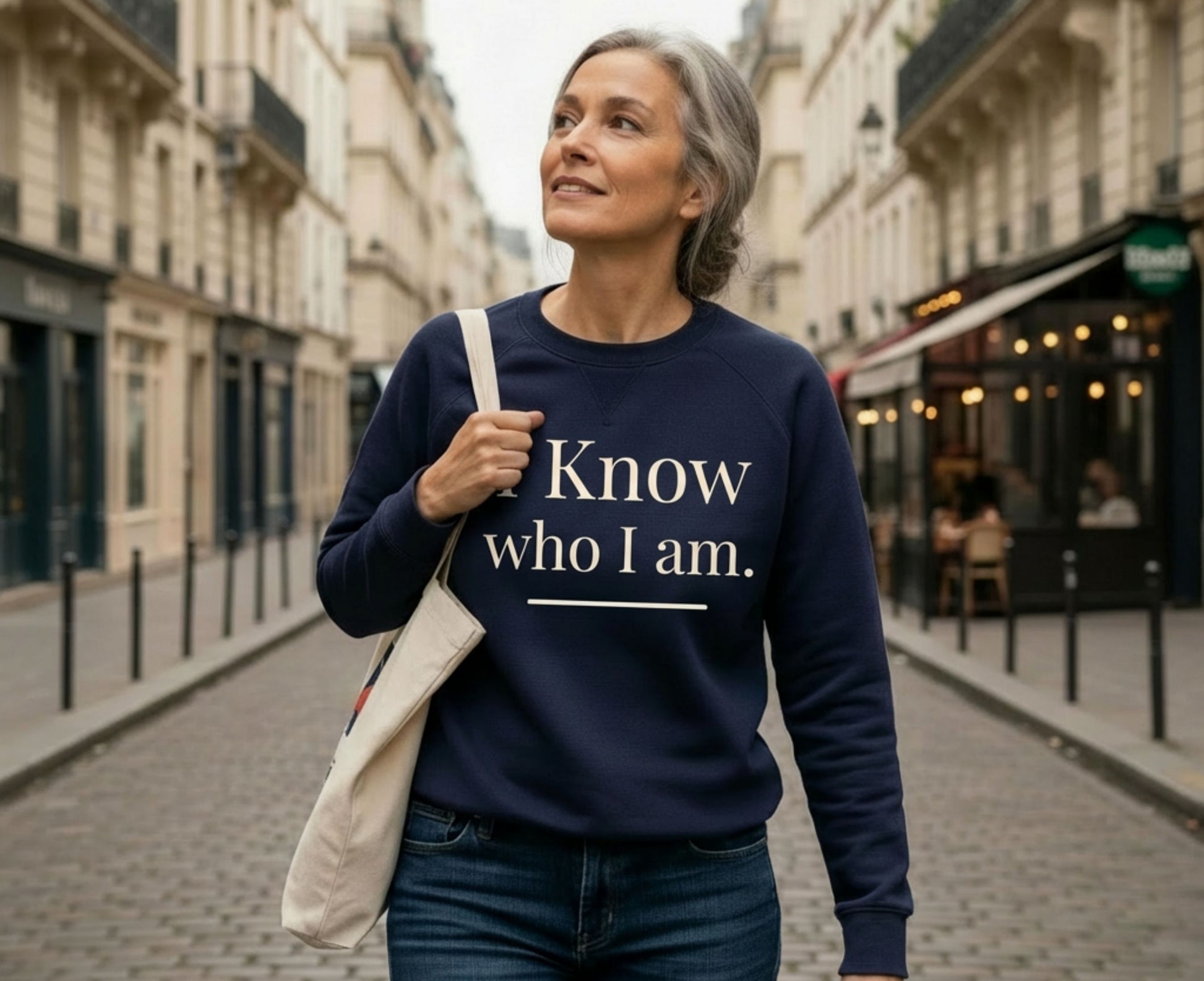 Woman wearing navy sweatshirt with "I Know who I am." text.