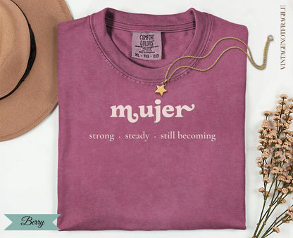 Berry Comfort Colors t-shirt with "mujer strong steady still becoming" text.