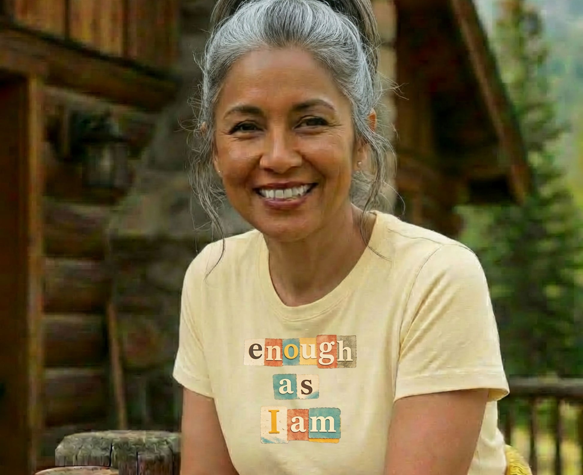 Woman wearing a light yellow t-shirt with "enough as I am" text.