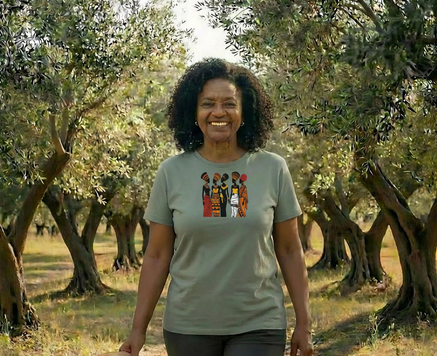 Smiling Black woman wearing a t-shirt with colorful African patterns.
