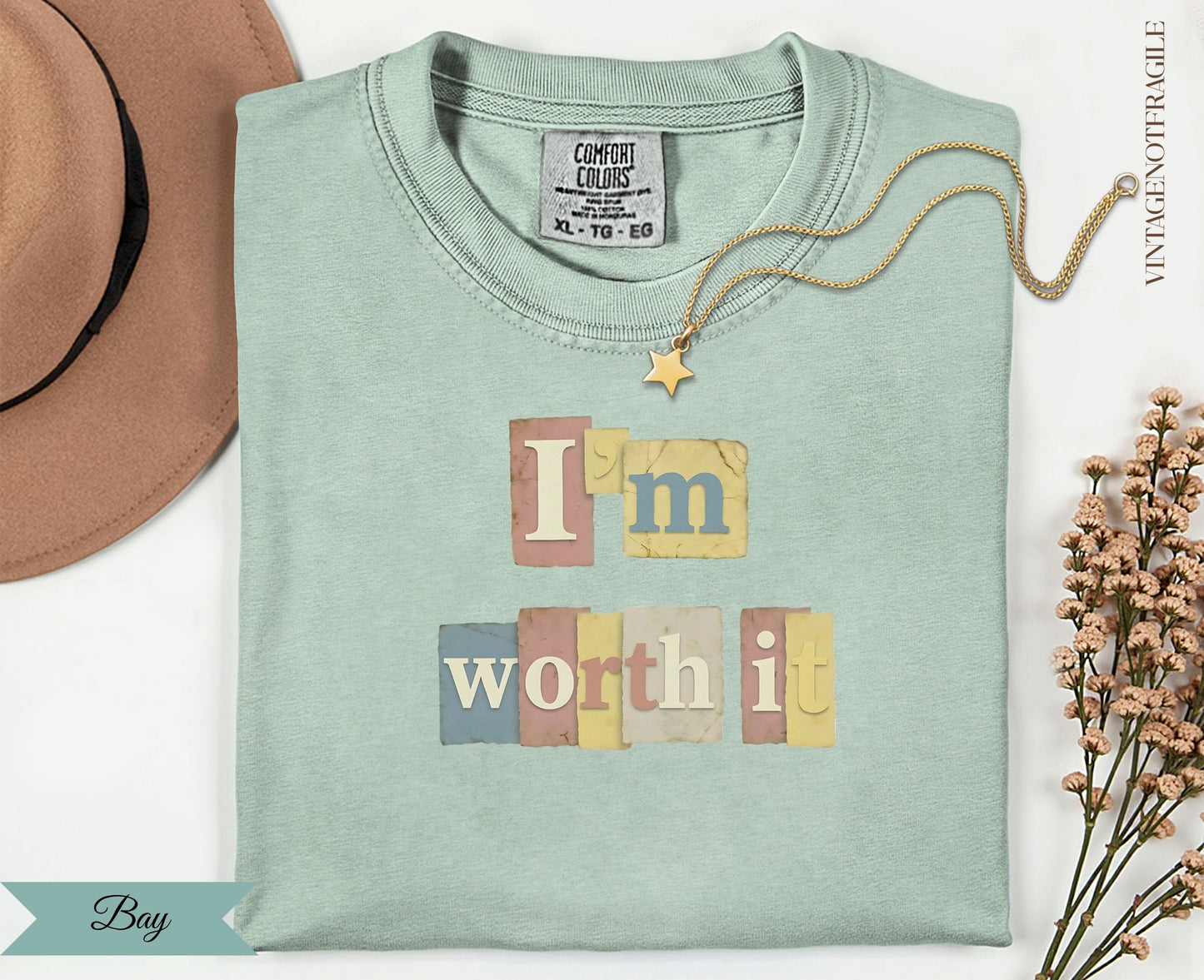 "I'm Worth It" text with a star on a light mint green t-shirt.