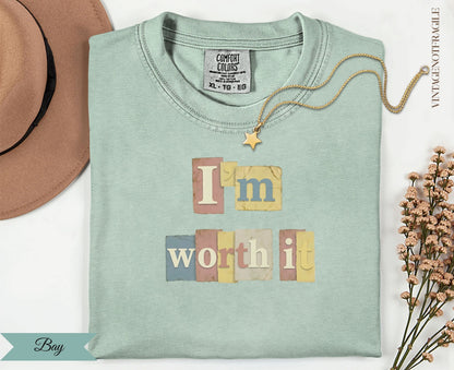 "I'm Worth It" text with a star on a light mint green t-shirt.