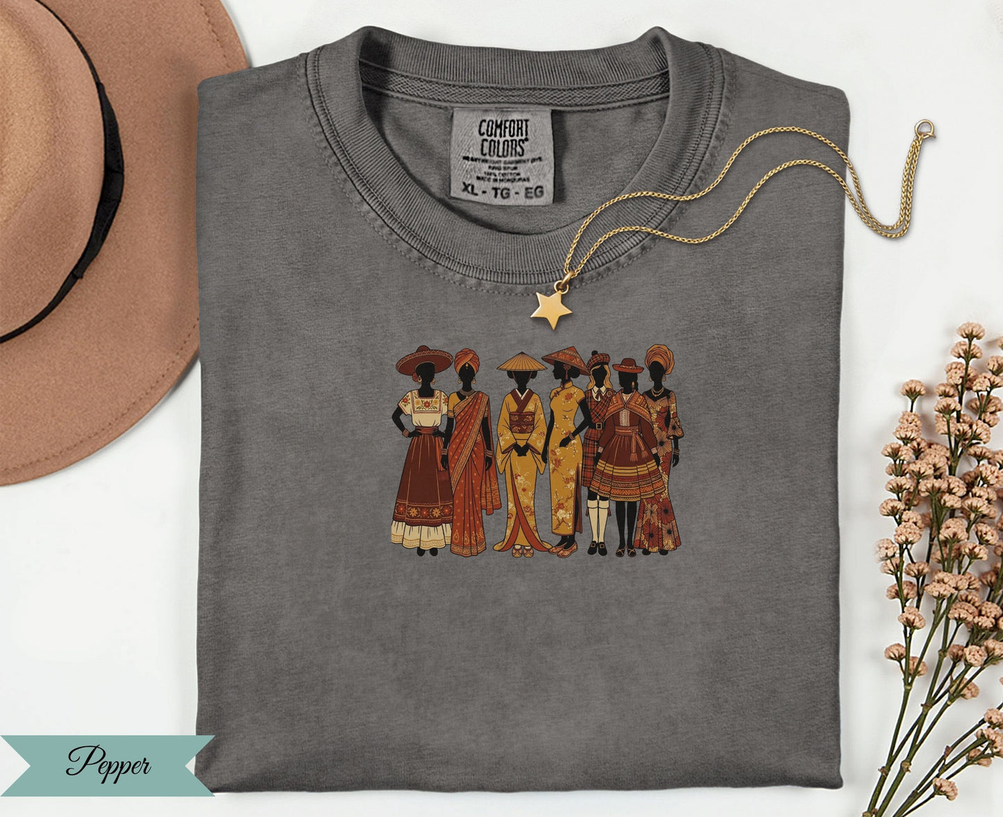 T-shirt featuring a diverse group of women in traditional clothing and a gold necklace.