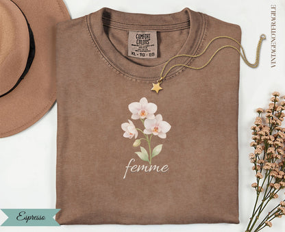 Brown Comfort Colors t-shirt with "femme" text and white orchid graphic.