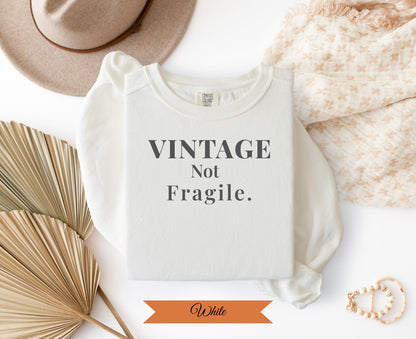 White Comfort Colors t-shirt with "Vintage Not Fragile" text.