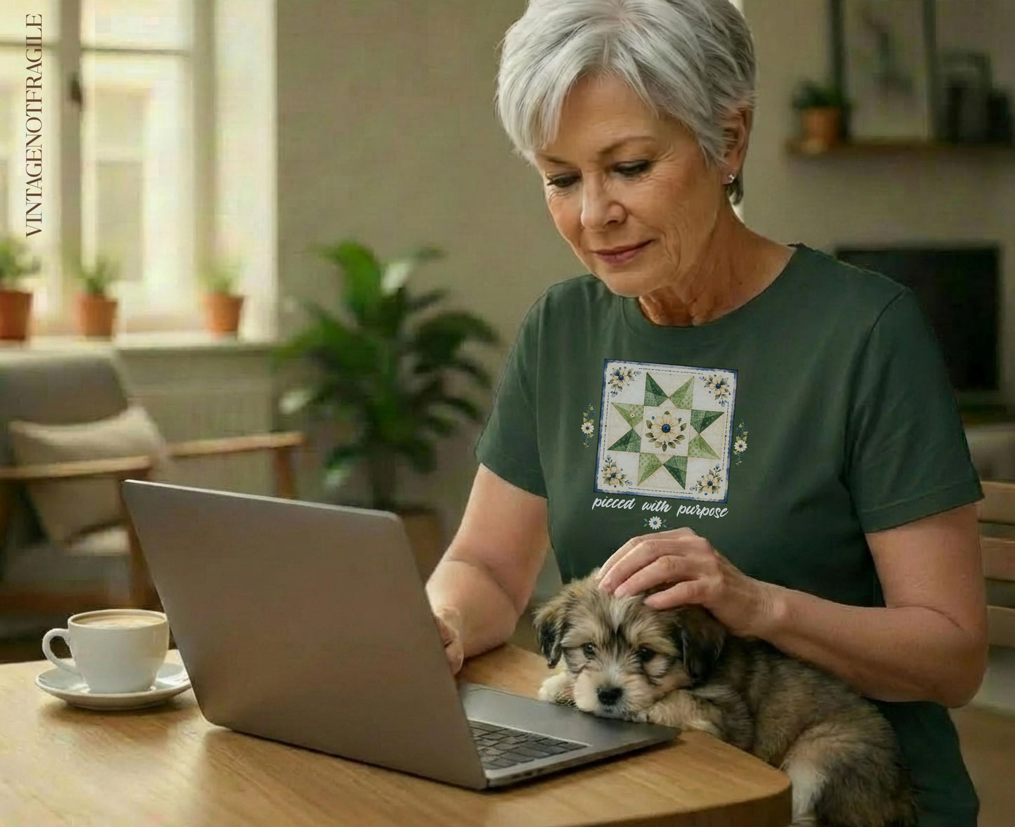 Woman petting a puppy while looking at a laptop, with a stitched quilt square on her shirt.