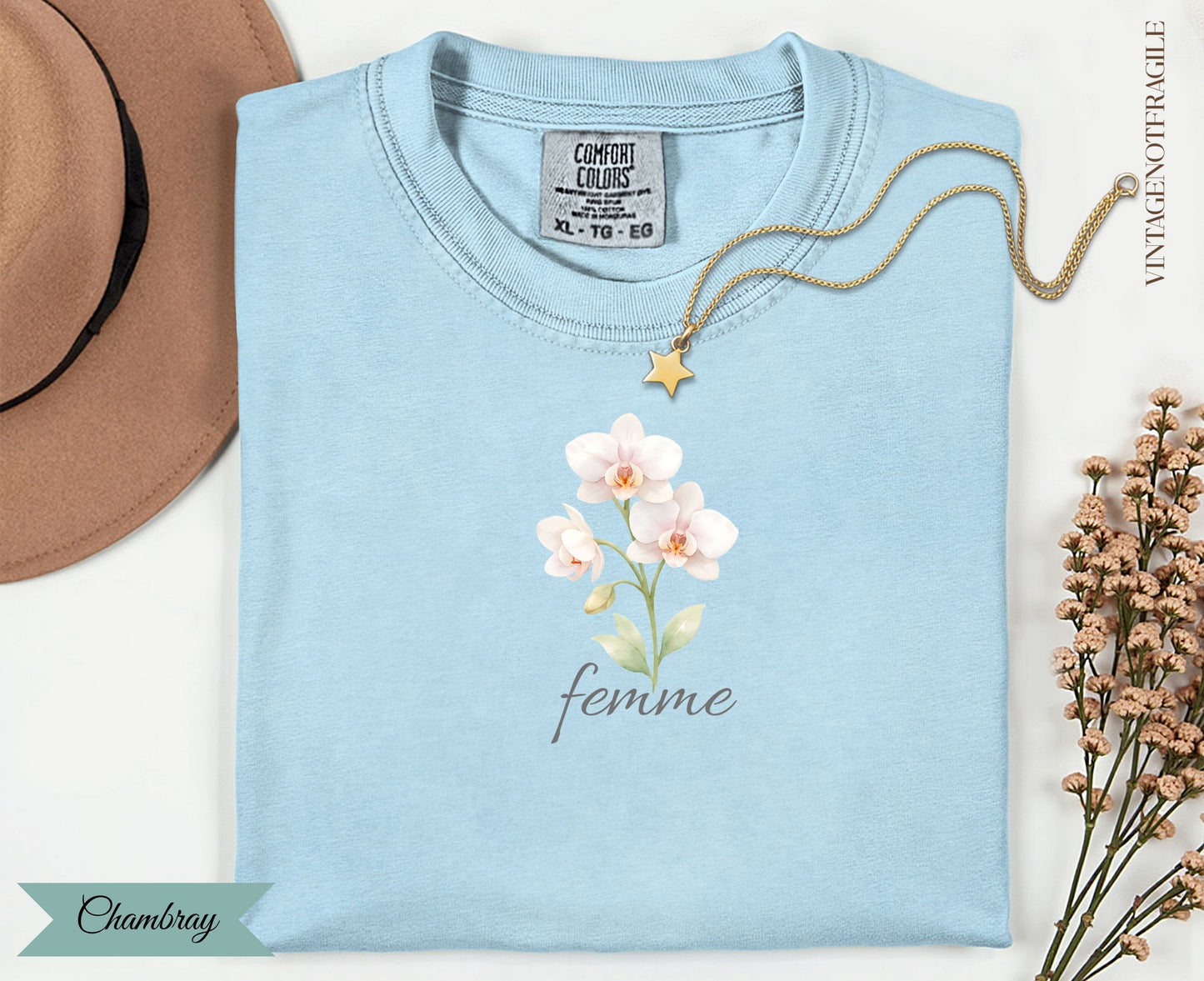 Light blue t-shirt with watercolor orchids and the word "femme".