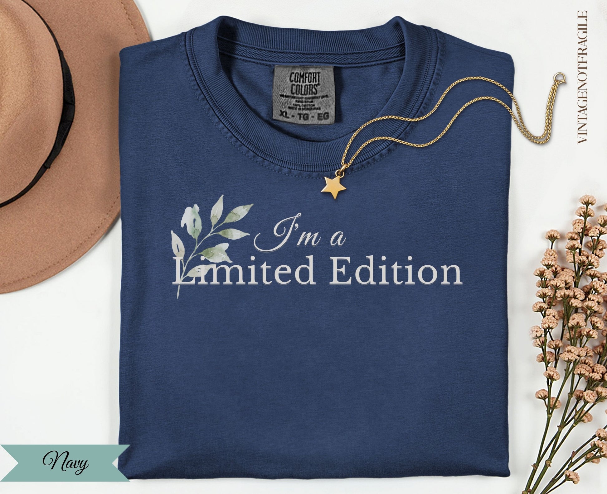 Navy t-shirt with "I'm a limited edition" text and floral design.