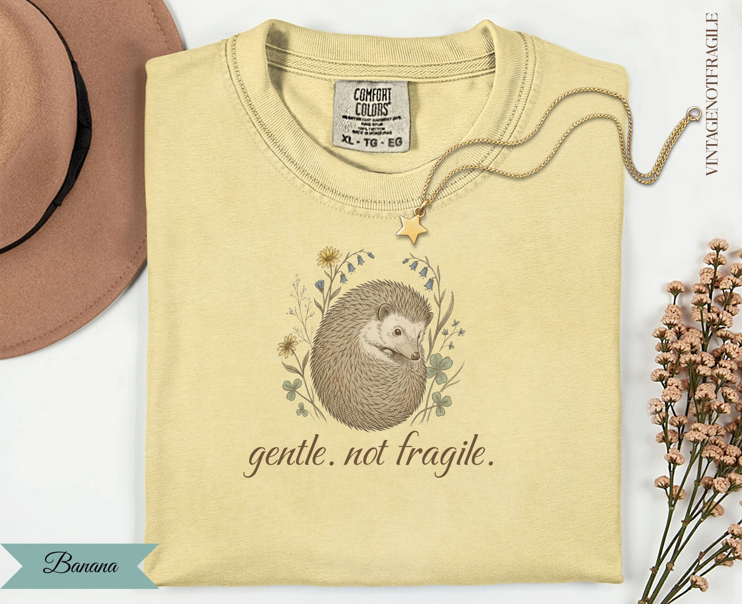 Yellow t-shirt with a hedgehog illustration and "gentle. not fragile." text.