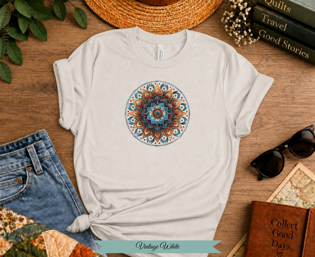 Cream t-shirt with colorful mandala print, paired with jeans and accessories.