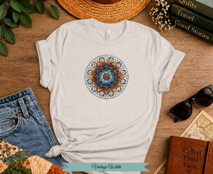Cream t-shirt with colorful mandala print, paired with jeans and accessories.