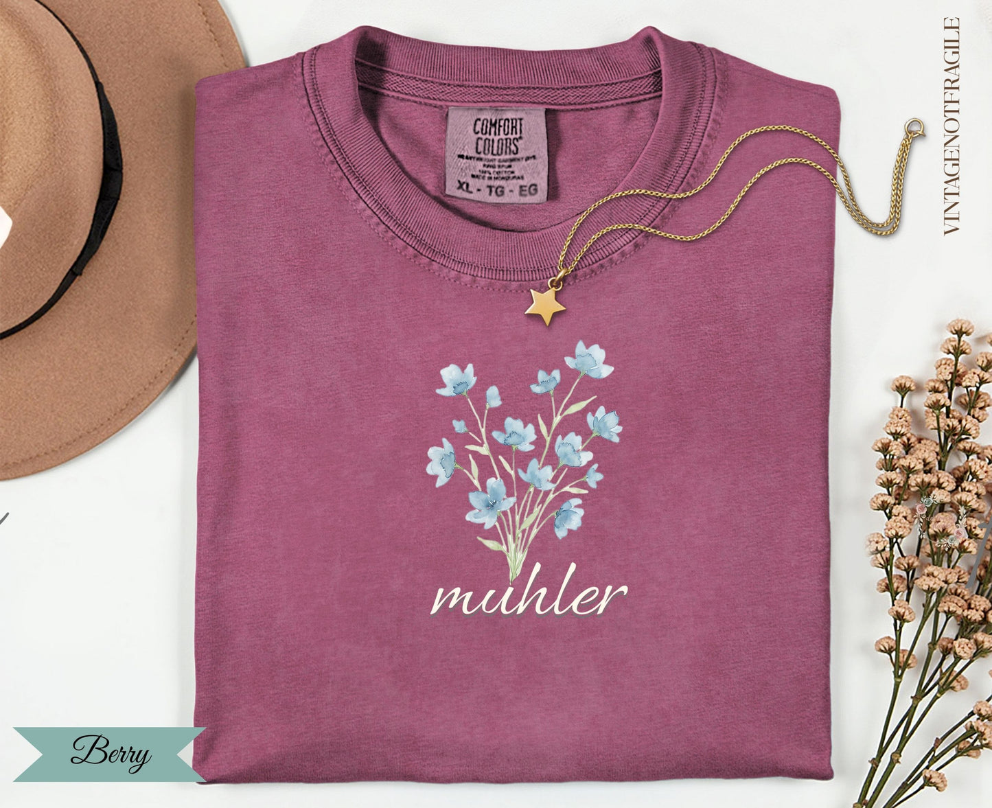Berry comfort colors t-shirt with blue flowers and "muhler" text.