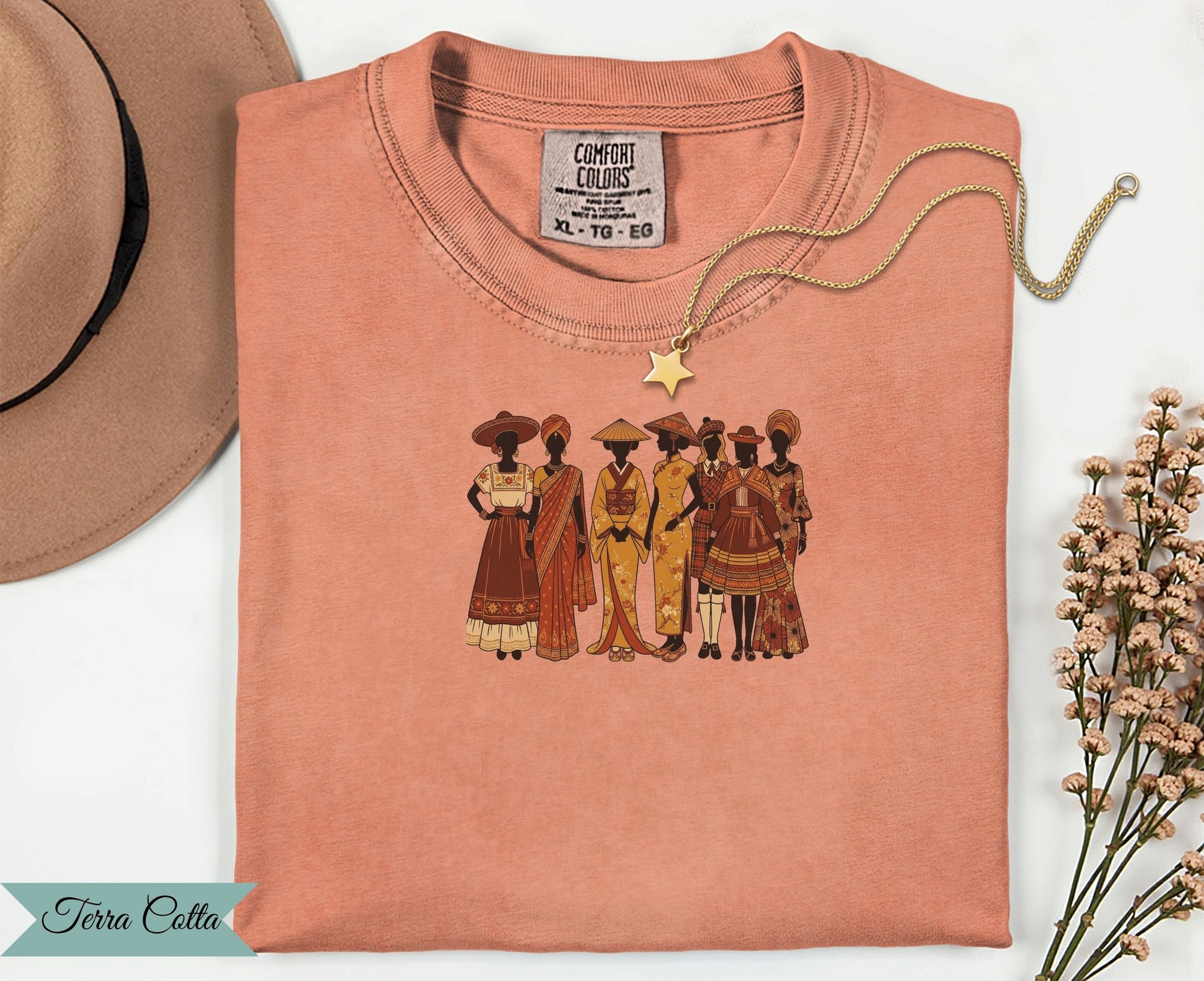 T-shirt with embroidered diverse women in traditional clothing and a gold necklace.