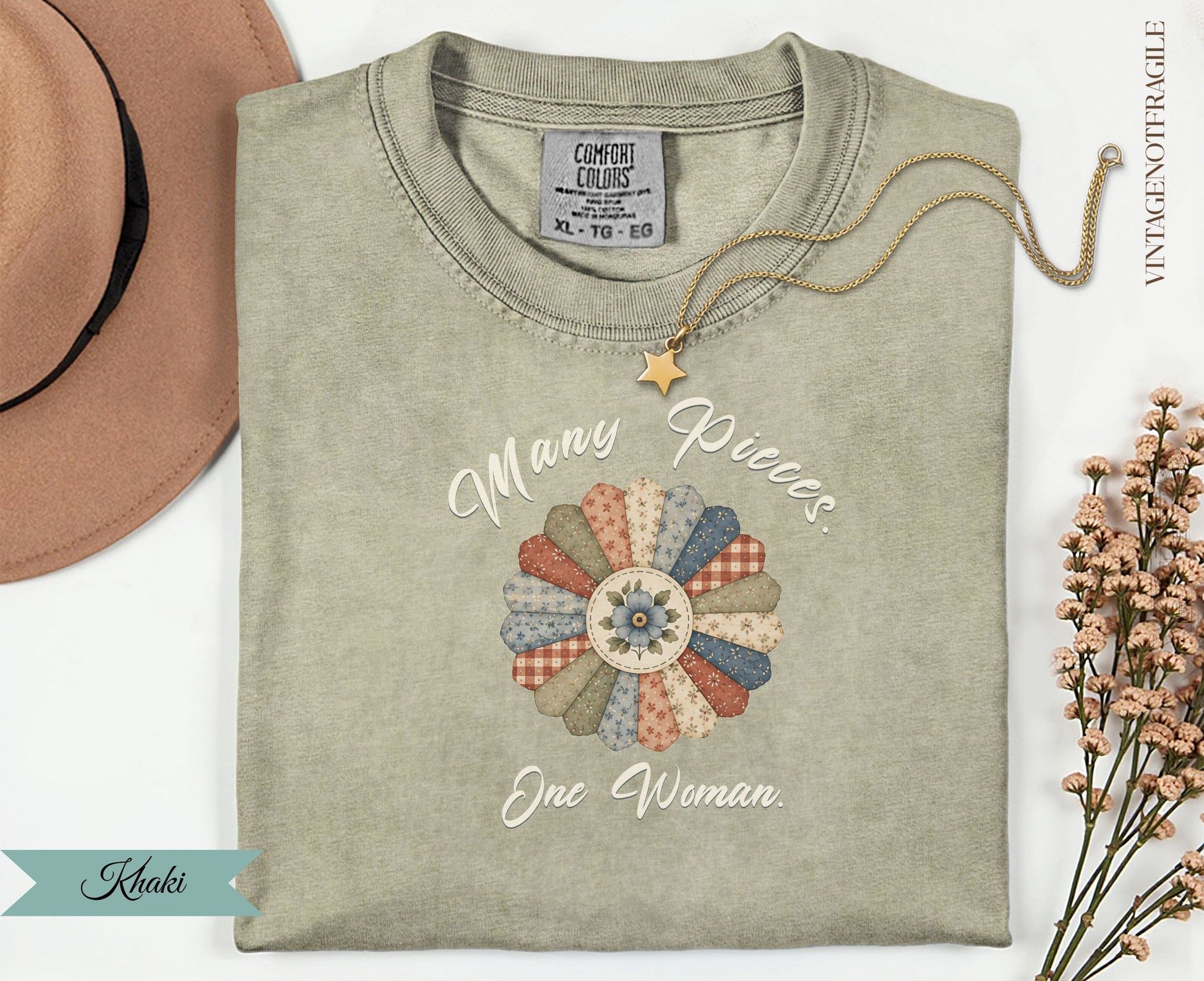 Khaki t-shirt with "Many Pieces. One Woman." text and floral quilt graphic.