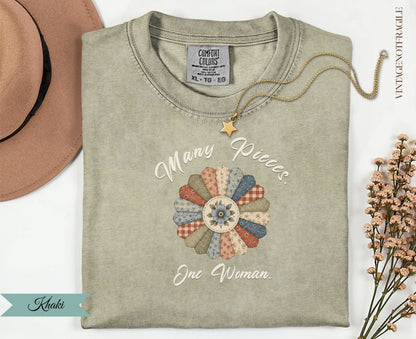Khaki t-shirt with "Many Pieces. One Woman." text and floral quilt graphic.