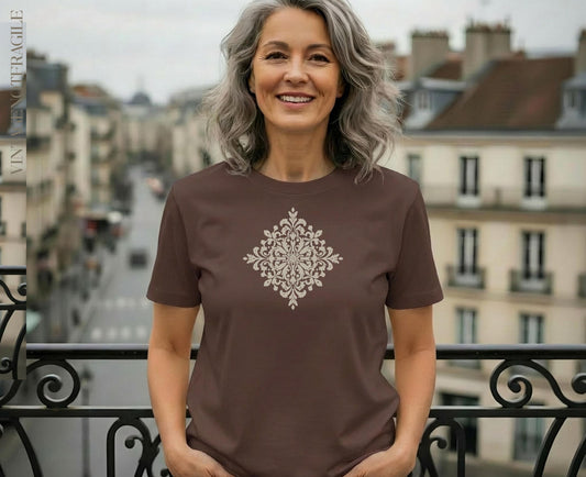 Brown t-shirt with ornate white medallion graphic.