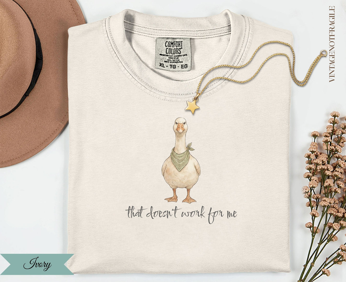 Cream t-shirt with goose illustration and "That doesn't work for me" text.