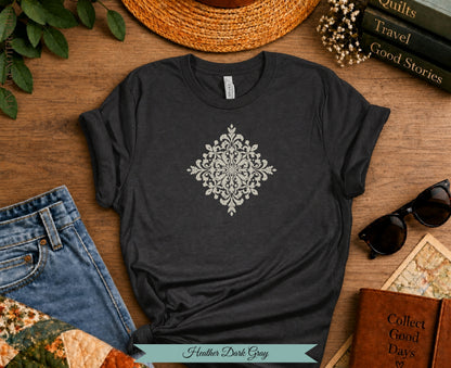 Heather Dark Gray t-shirt with ornate white damask design, jeans, sunglasses, and books.