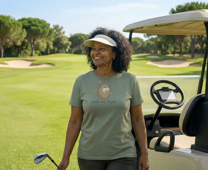 Woman on golf course wearing t-shirt with hedgehog graphic and text.