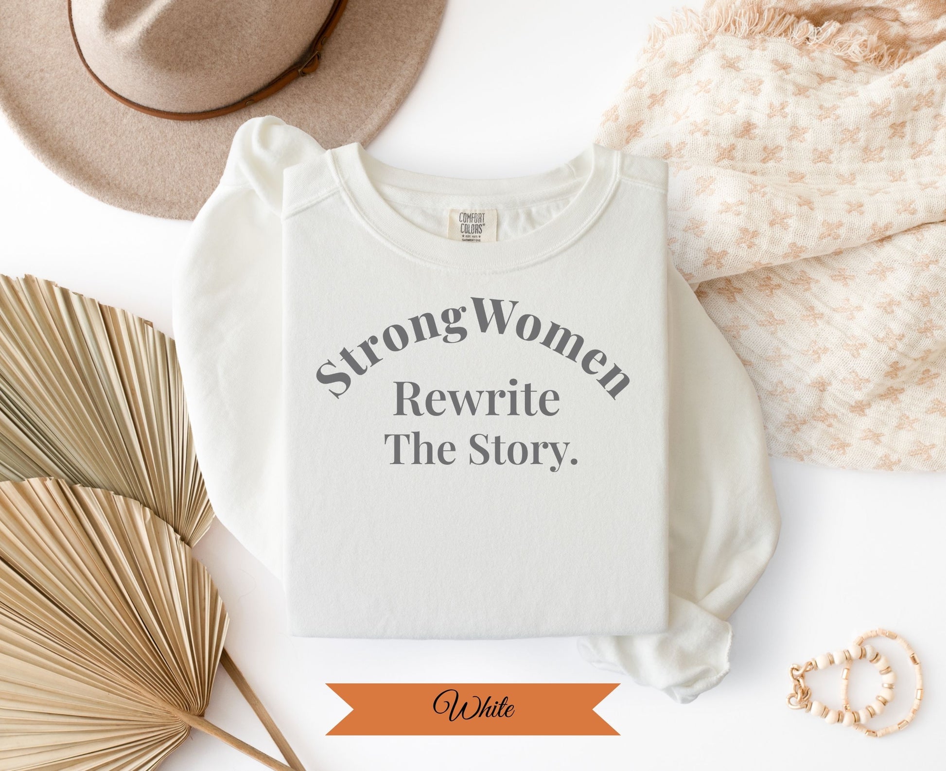 Comfort Colors white t-shirt with "Strong Women Rewrite The Story" text.