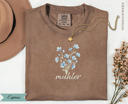 Espresso t-shirt with blue floral bouquet graphic and "muhler" text.