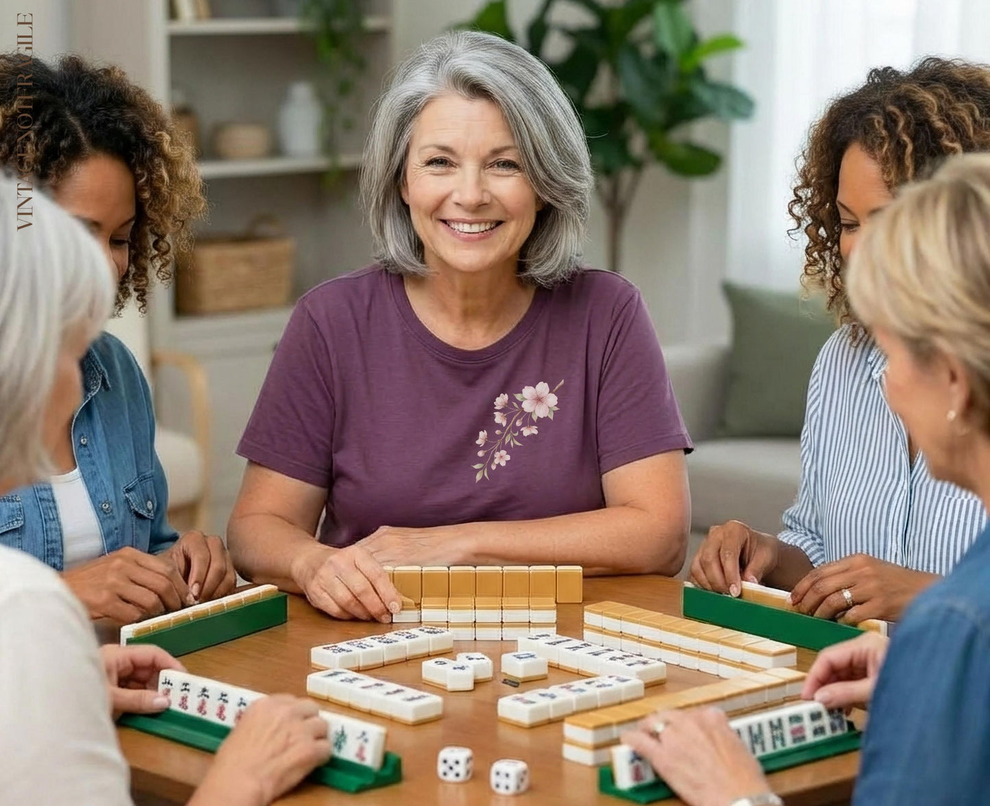 Four women playing Mahjong around a table, one smiling at the camera.