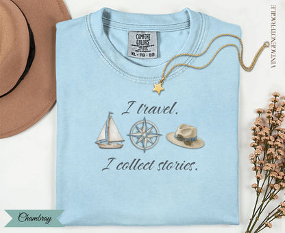 Light blue t-shirt with "I travel. I collect stories." and travel icons.