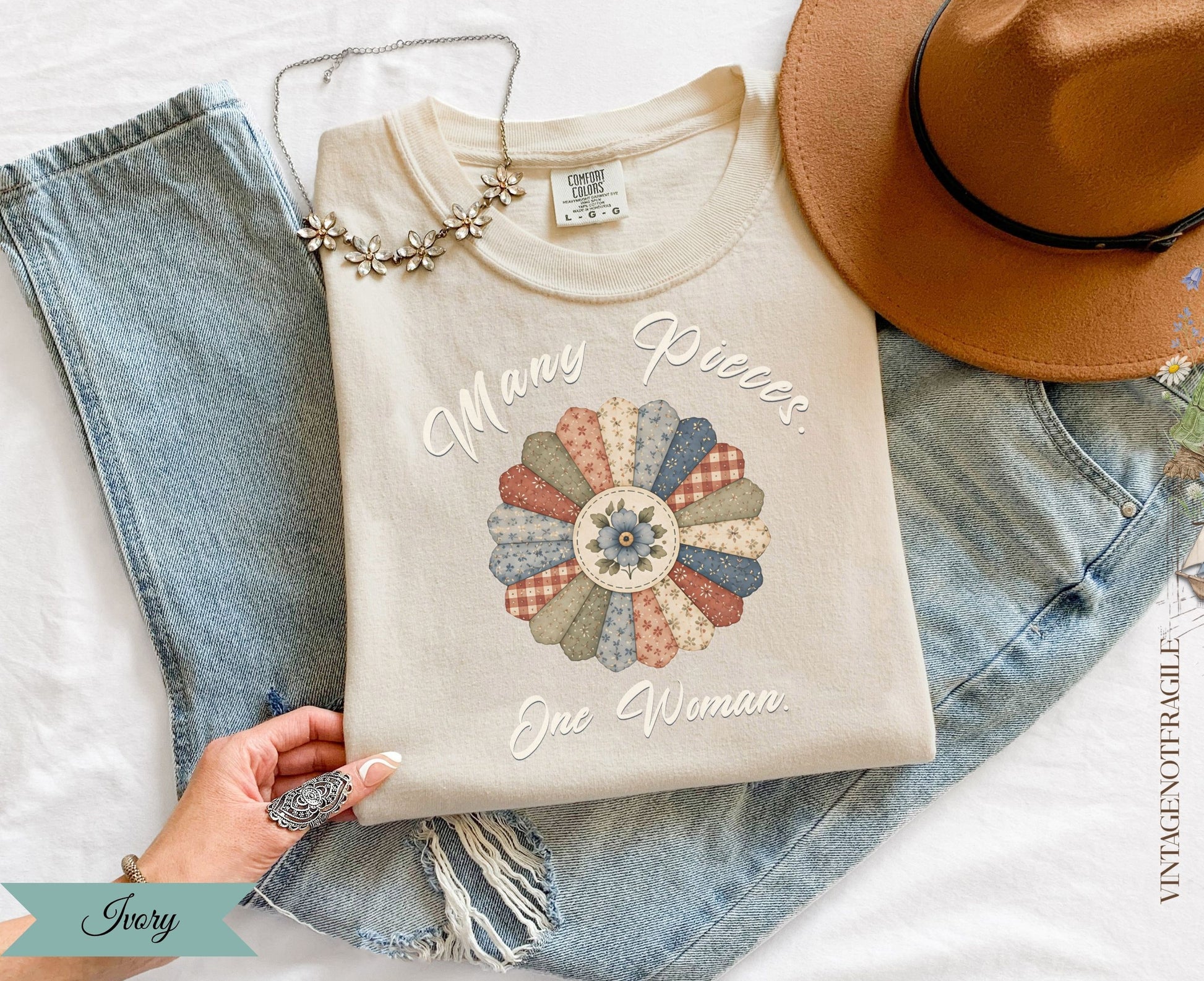 Cream sweatshirt with "Many Pieces. One Woman." text and a floral quilt design.