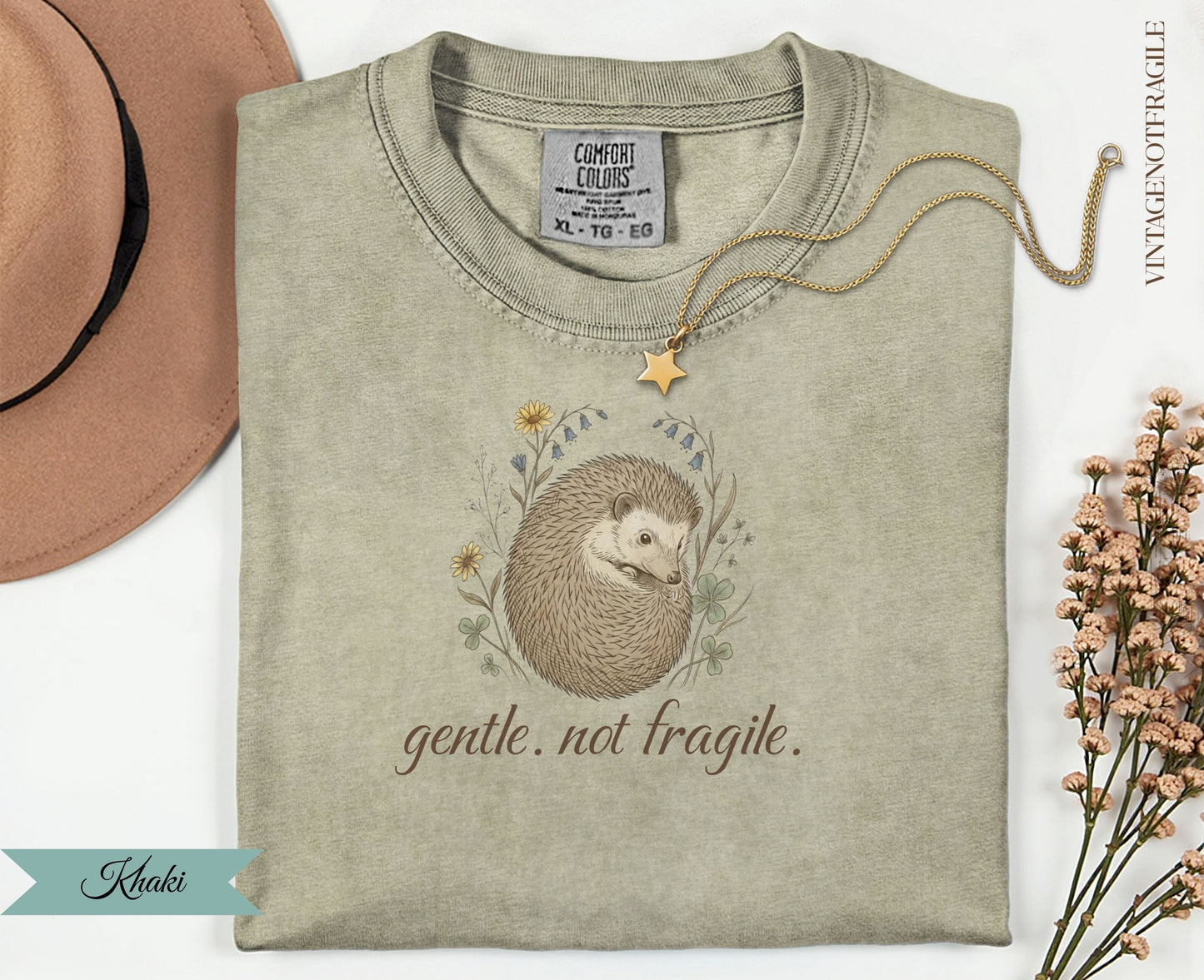 Khaki t-shirt with a hedgehog illustration and "gentle. not fragile." text.