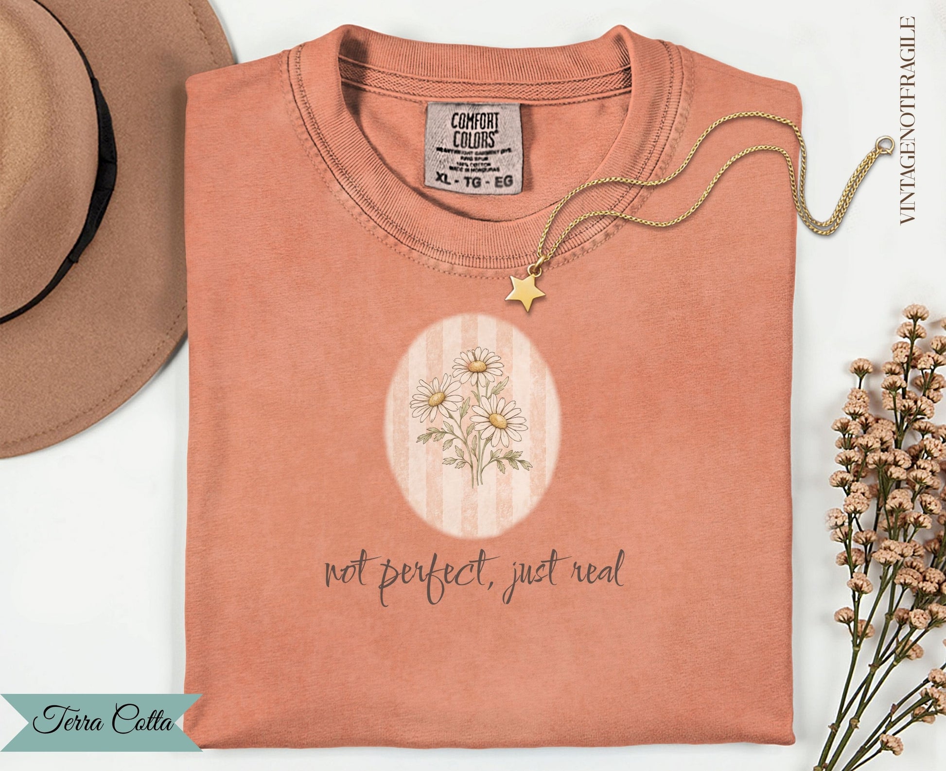 Coral t-shirt with floral graphic and "not perfect, just real" text.