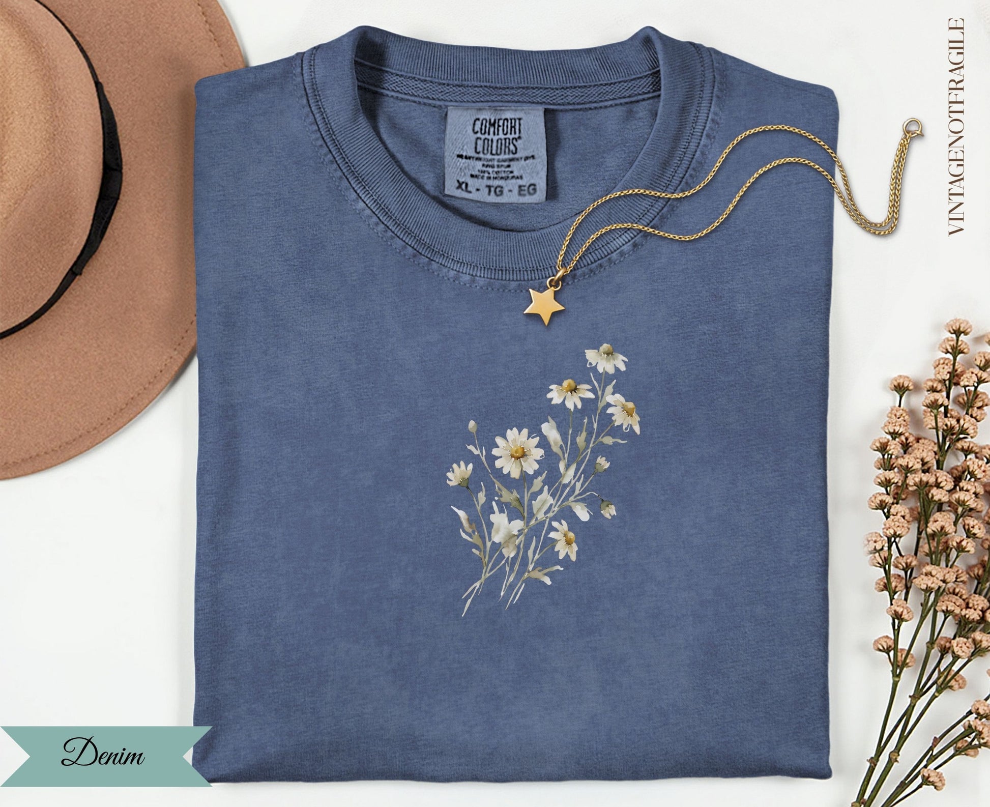 Denim t-shirt with a delicate floral daisy design and a gold star necklace.