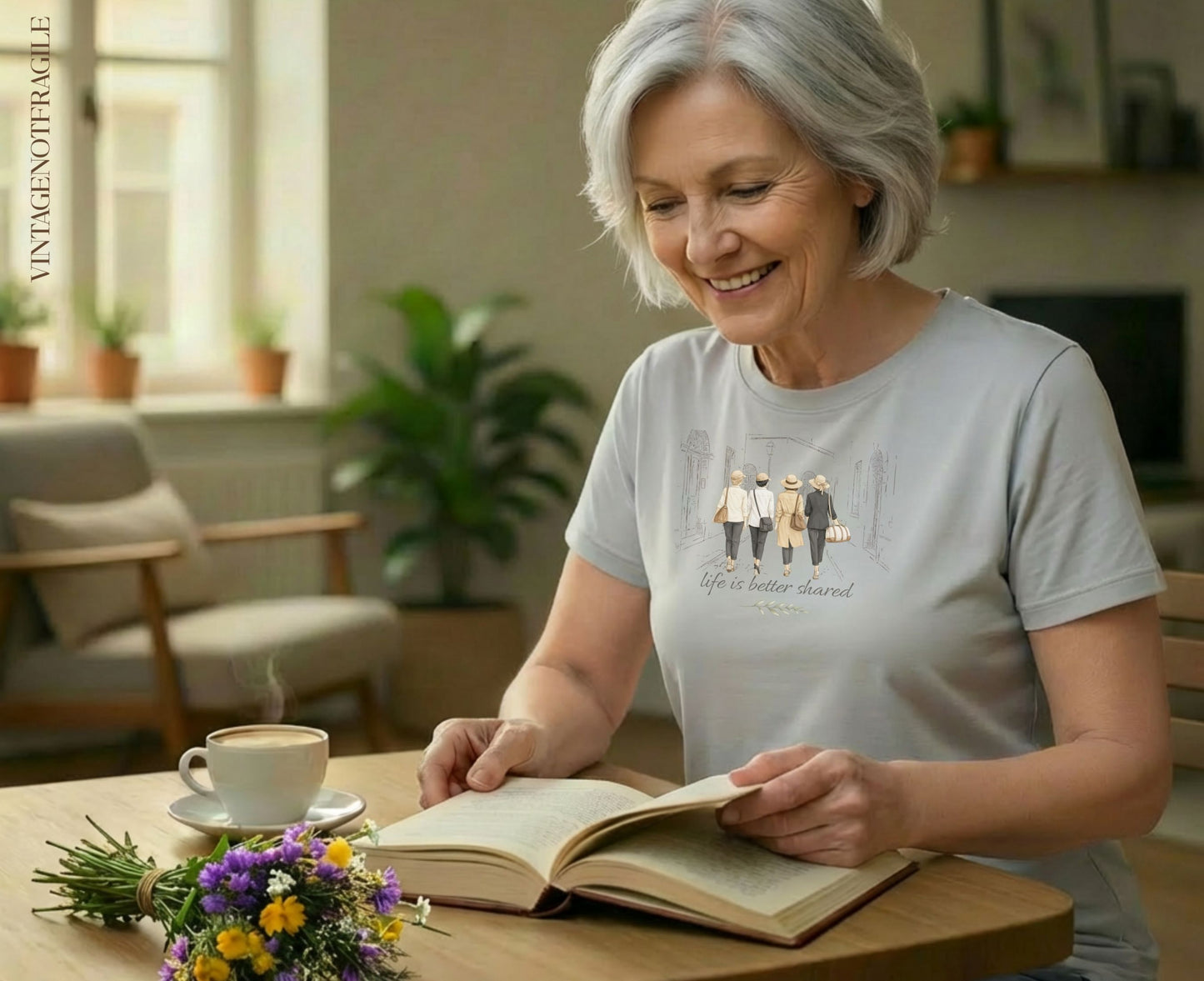 Woman reading a book with a graphic of four women walking on her shirt.