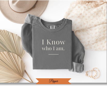 Grey sweatshirt with "I Know who I Am." text and "Popper" label.