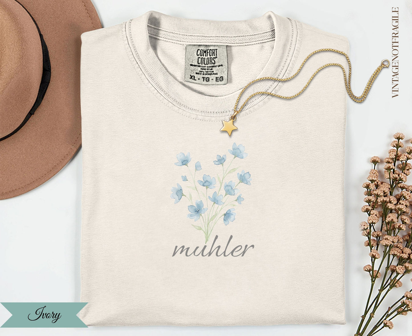 Cream t-shirt with blue floral design and "muhler" text.