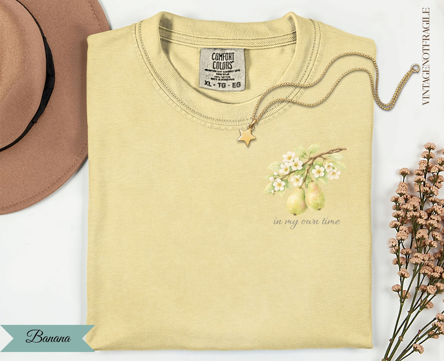 Yellow t-shirt with pear branch graphic and "in my own time" text.