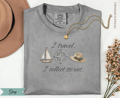 Gray Comfort Colors t-shirt with "I travel. I collect stories." and travel graphics.