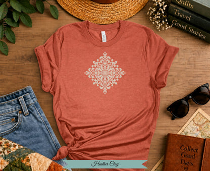 Coral t-shirt with white damask print, tied knot, and "Heather Clay" text.