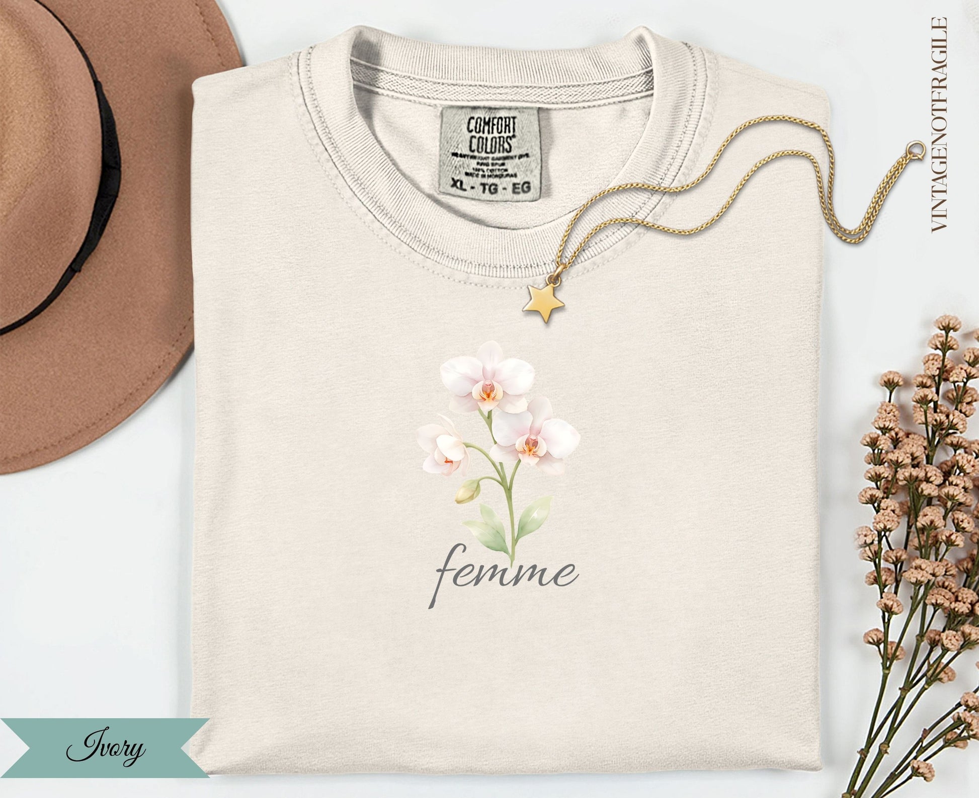 Cream t-shirt with "femme" text and three pale pink orchids.