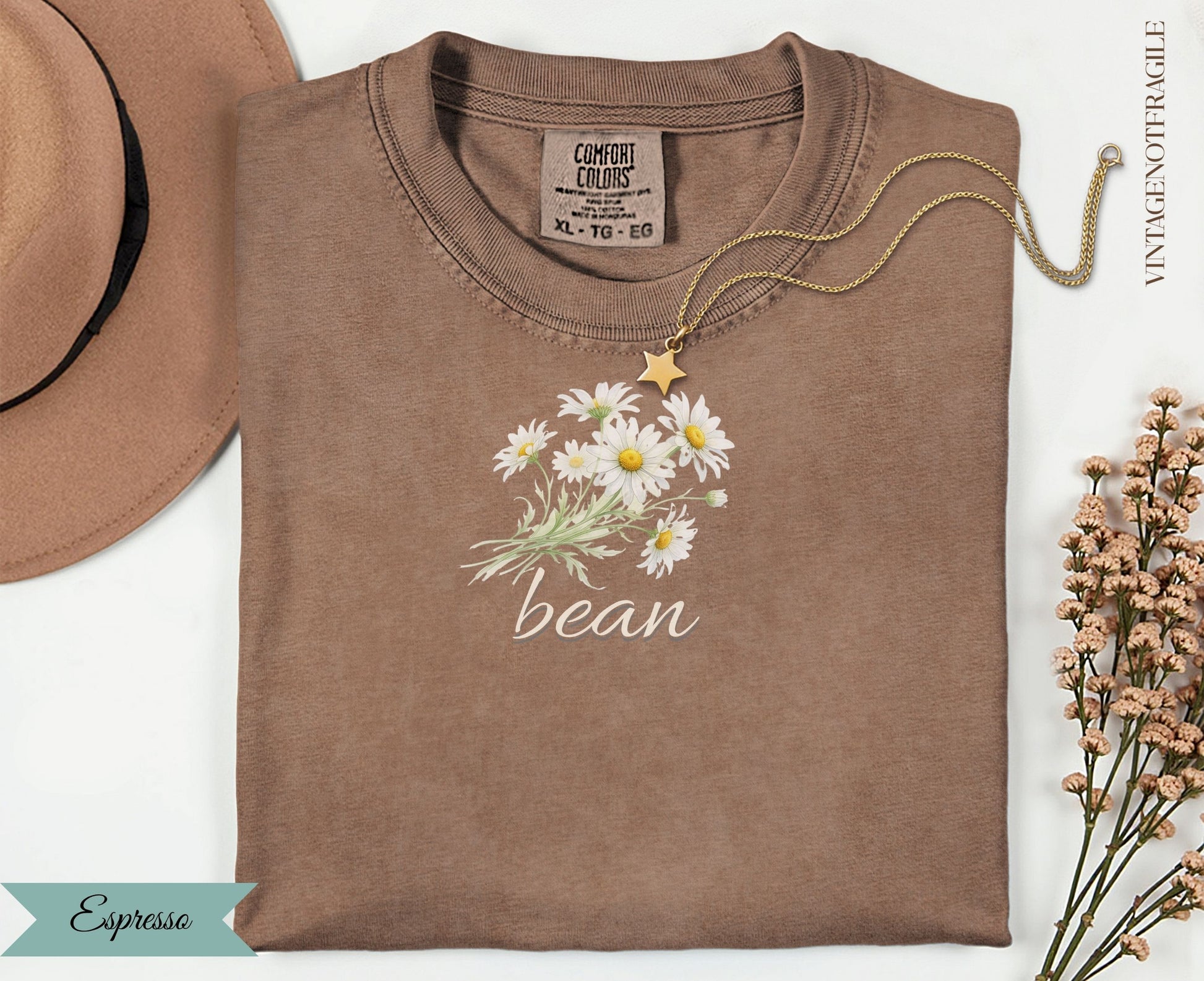 Brown Comfort Colors t-shirt with daisy bouquet and "bean" text.
