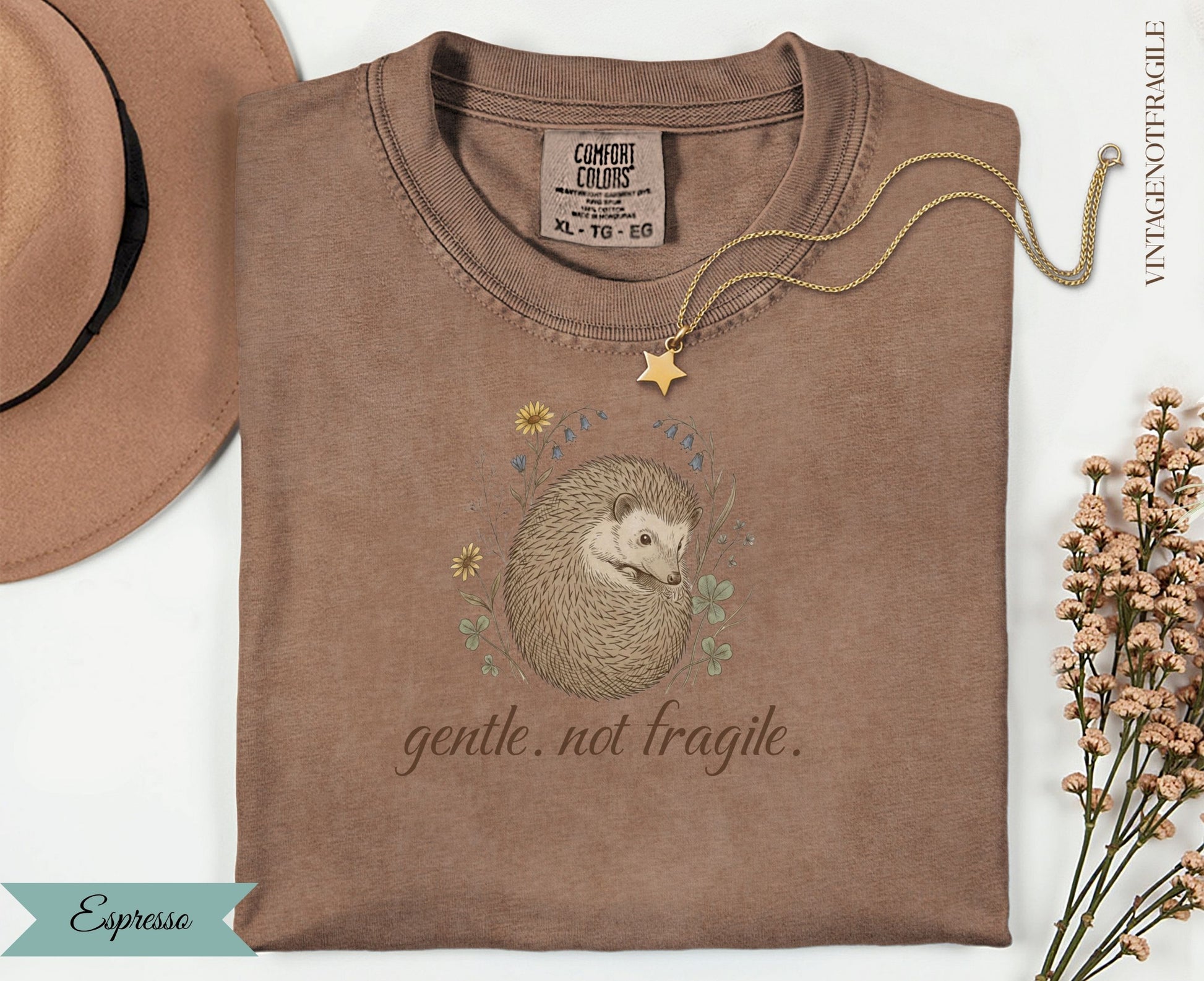 Brown t-shirt with hedgehog and floral design, "gentle. not fragile." text.
