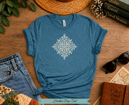 Heather Deep Teal t-shirt with vintage-style snowflake design and rolled sleeves.