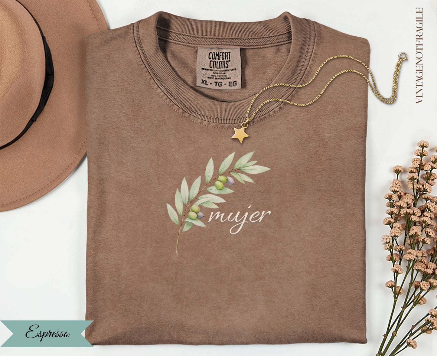 Brown t-shirt with olive branch and "mujer" text, with gold necklace.