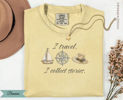 Yellow graphic t-shirt with "I travel. I collect stories." text and sailboat.