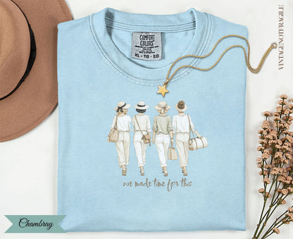 Light blue t-shirt with graphic of four women in hats and white outfits; text "we made time for this".