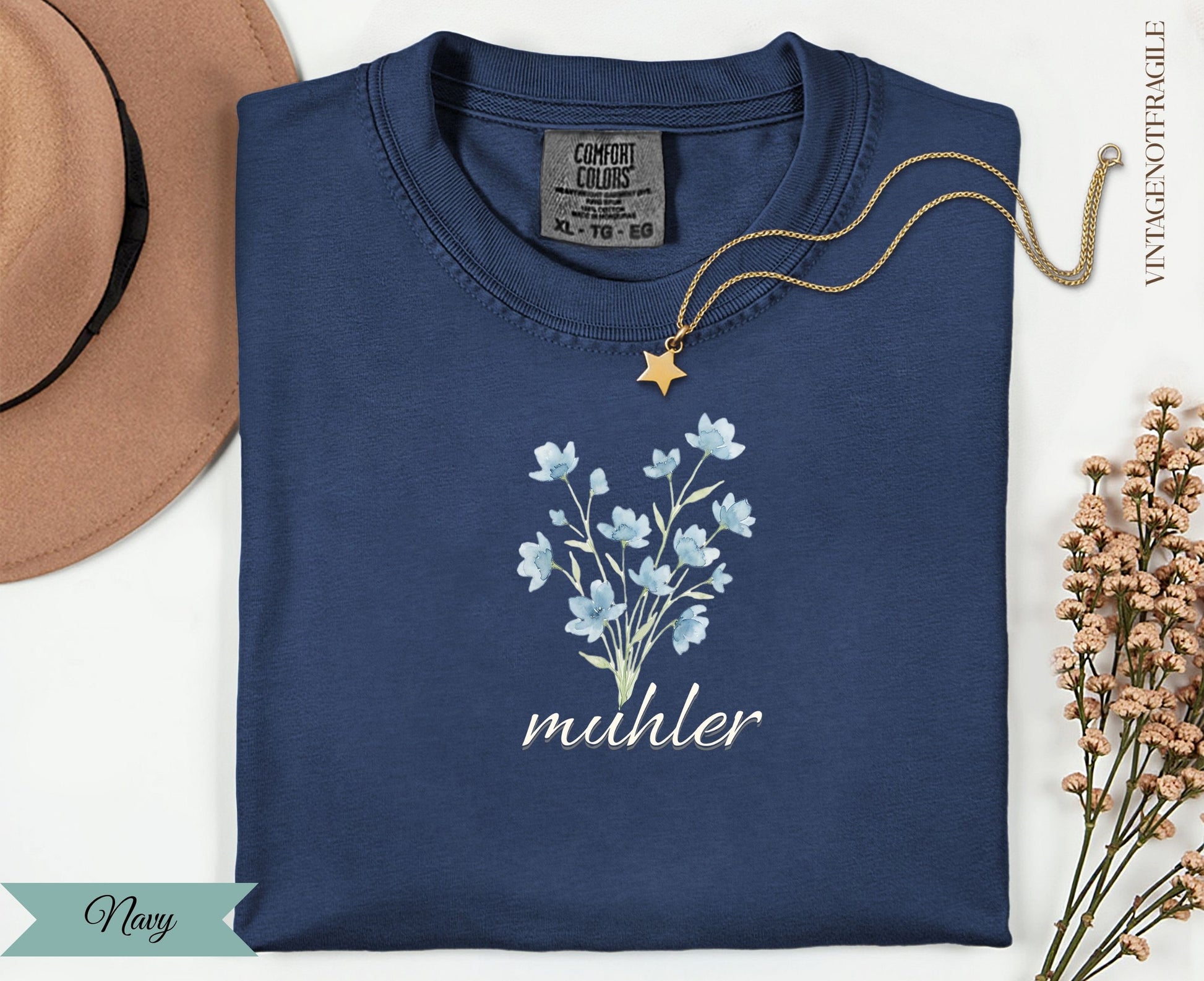 Navy Comfort Colors t-shirt with delicate blue flowers and "muhler" text.